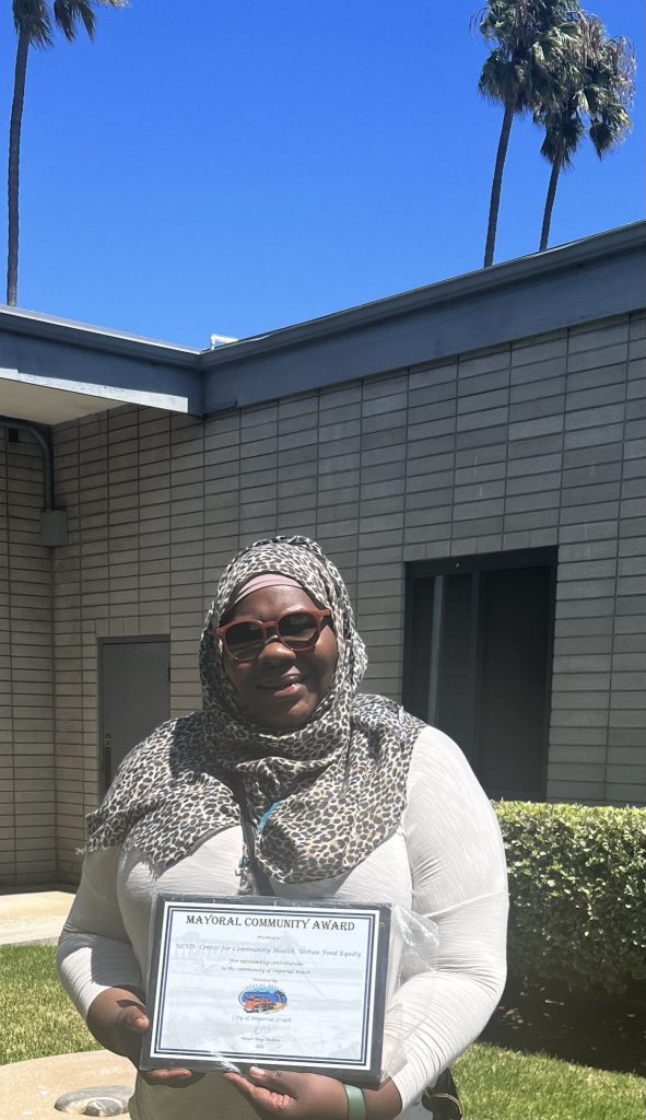 woman holding a certificate/award